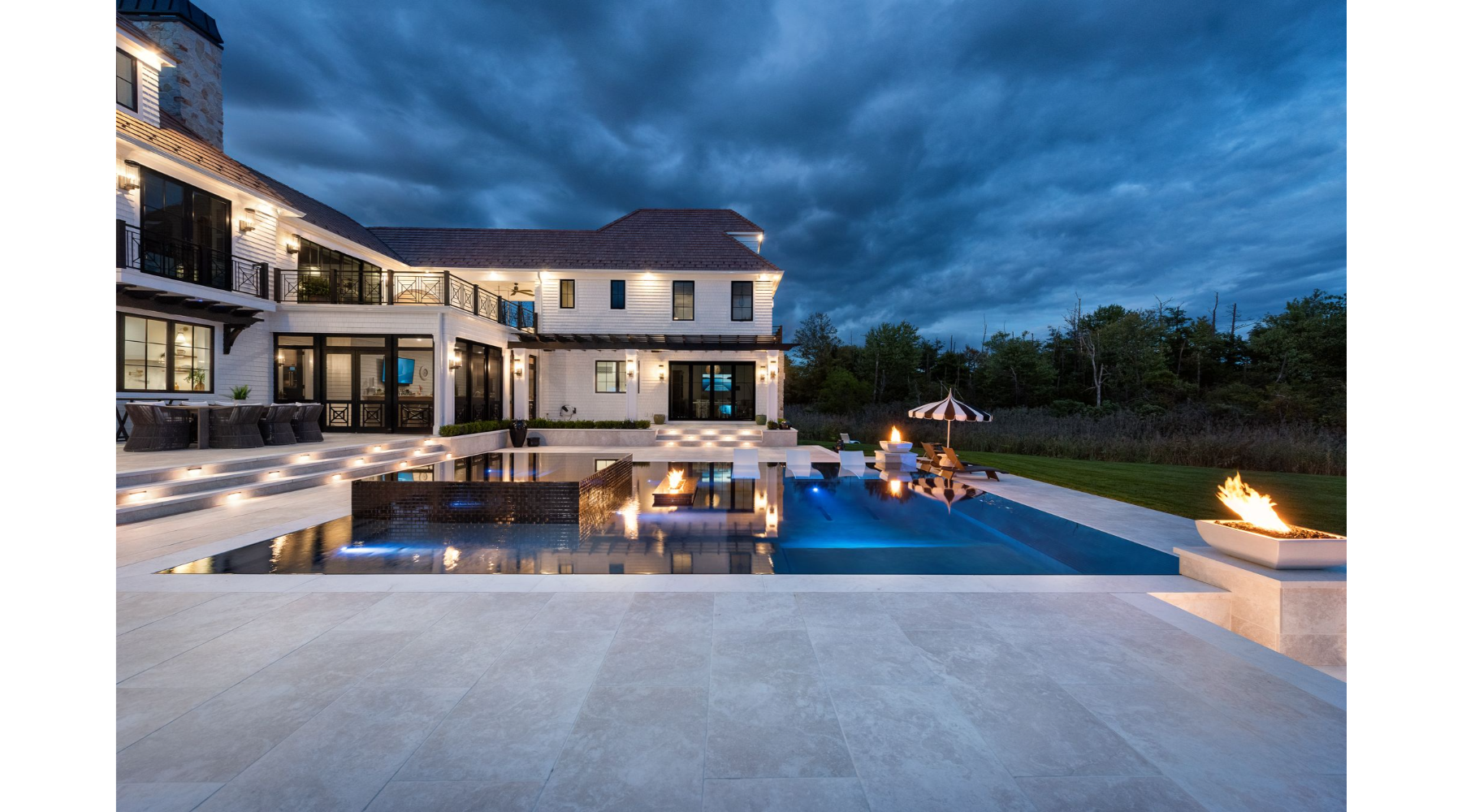 Luxury mansion backyard with pool and elegant fire and water features